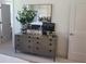 Stylish bedroom showcasing a gray dresser with plants and decorative items, complemented by a framed mirror at 508 Zeal Se St # 292, Atlanta, GA 30315