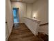 Bright hallway with wood floors leads to a bedroom with natural light and a staircase with wood treads at 508 Zeal Se St # 292, Atlanta, GA 30315