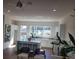 Bright, open living space featuring a kitchen island with barstool seating, white cabinets, and a large window at 508 Zeal Se St # 292, Atlanta, GA 30315