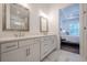 Bathroom featuring double sinks, shower, and marble tile at 104 Ivey Way, Woodstock, GA 30188