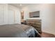 Bedroom with view into living space featuring a flat screen TV, wooden floor and light at 104 Ivey Way, Woodstock, GA 30188