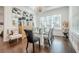 Bright dining area with stylish furniture and a large window that provide natural light and beautiful views at 104 Ivey Way, Woodstock, GA 30188