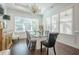 Elegant dining room featuring a modern chandelier, and a glass dining table with seating for six at 104 Ivey Way, Woodstock, GA 30188