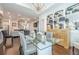 Open-concept dining area with modern lighting and elegant decor and views into the living room at 104 Ivey Way, Woodstock, GA 30188