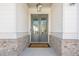 Elegant double front doors feature glass panes, and offer views to the home's interior at 104 Ivey Way, Woodstock, GA 30188