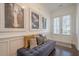 Bright foyer with statement art, a tufted bench, and double doors with sidelights at 104 Ivey Way, Woodstock, GA 30188