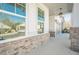 Covered porch with brick base offers shelter and complements the home's design at 104 Ivey Way, Woodstock, GA 30188