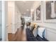 Inviting foyer with hardwood floors, a bench, and decorative wall decor at 104 Ivey Way, Woodstock, GA 30188