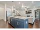 Spacious kitchen island flows into an open concept living room with fireplace at 104 Ivey Way, Woodstock, GA 30188