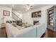 Open-concept living area with fireplace, large sectional and hardwood floors at 104 Ivey Way, Woodstock, GA 30188