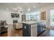Open concept living room and kitchen with hardwood floors and fireplace at 104 Ivey Way, Woodstock, GA 30188