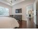 Bright, spacious bedroom features tray ceilings, TV, and hardwood floors at 104 Ivey Way, Woodstock, GA 30188