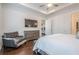 Bright bedroom with large TV, chair, and door leading to ensuite bathroom at 104 Ivey Way, Woodstock, GA 30188