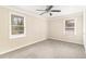 Bright bedroom with carpet, ceiling fan, and dual windows at 2053 Wells Sw Dr, Atlanta, GA 30311