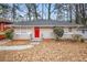 Brick ranch house with red door, gray steps, and a tree-lined yard at 2053 Wells Sw Dr, Atlanta, GA 30311