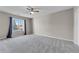 Bright bedroom with window, ceiling fan, and neutral gray carpet at 308 Spring Heights Ln # 308, Smyrna, GA 30080