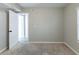 Bedroom with carpet, door to another room, and window at 5910 Rock Rd, Union City, GA 30291