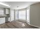 Spacious dining area with a bay window and dark wood-look flooring at 5910 Rock Rd, Union City, GA 30291