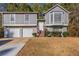 Gray two-story house with attached two-car garage and brown wooden steps at 5910 Rock Rd, Union City, GA 30291