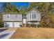 Two-story house featuring gray siding, a two-car garage, and a bay window at 5910 Rock Rd, Union City, GA 30291