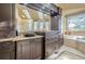 Elegant bathroom with dark wood cabinets, granite counters, and a large soaking tub at 2727 Jamerson Rd, Marietta, GA 30066