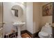 Elegant powder room with pedestal sink, toilet, and decorative artwork at 2727 Jamerson Rd, Marietta, GA 30066