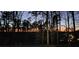 A view of a private street lined with trees and distant homes at sunset at 2727 Jamerson Rd, Marietta, GA 30066