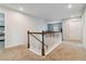 Upstairs hallway with carpeted floors and wooden railing at 340 Paulownia Cir, Mcdonough, GA 30253