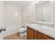 Traditional bathroom with combination tub and shower, wood cabinet and single sink at 85 Blue Jay Dr, Covington, GA 30016