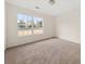 A bright bedroom features neutral carpet and a large window at 85 Blue Jay Dr, Covington, GA 30016