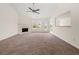 Bright living room with fireplace, plush carpet and large windows at 85 Blue Jay Dr, Covington, GA 30016