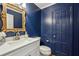 Powder room with navy blue walls, white vanity, and ornate gold mirror at 2773 Townley Cir, Atlanta, GA 30340