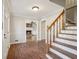 Brick floor entryway with wooden staircase and view to living room with fireplace at 2773 Townley Cir, Atlanta, GA 30340