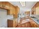 Long kitchen with wood cabinets, granite counters, and terracotta tile floors at 2773 Townley Cir, Atlanta, GA 30340