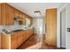 View of kitchen with wood cabinets, granite countertops, and terracotta tile floors at 2773 Townley Cir, Atlanta, GA 30340