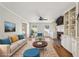 Virtually staged living room with hardwood floors, fireplace, and built-in shelving at 2773 Townley Cir, Atlanta, GA 30340