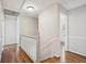 Upstairs hall with hardwood floors and white railings at 2773 Townley Cir, Atlanta, GA 30340