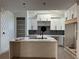 Modern kitchen with white cabinets, large island, and dark backsplash at 429 Grant Se St, Atlanta, GA 30312