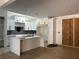 Modern kitchen with white cabinets, large island, and dark backsplash at 429 Grant Se St, Atlanta, GA 30312