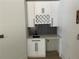 Built-in wet bar with white shaker cabinets and black hardware at 429 Grant Se St, Atlanta, GA 30312