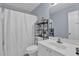 Bathroom with shower-tub combo, storage shelves, and good lighting at 625 Piping Rock Pt, Lawrenceville, GA 30043