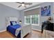 Bedroom featuring a ceiling fan, hardwood floors and large windows at 625 Piping Rock Pt, Lawrenceville, GA 30043