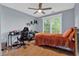 Well-lit bedroom featuring hardwood floors and a modern ceiling fan at 625 Piping Rock Pt, Lawrenceville, GA 30043
