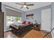 Charming bedroom with hardwood floors, a ceiling fan and neutral colors at 625 Piping Rock Pt, Lawrenceville, GA 30043