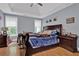 Bedroom with wood floors, blue accents, and ample natural light from two windows at 625 Piping Rock Pt, Lawrenceville, GA 30043