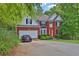 Charming brick home featuring manicured landscaping, a two-car garage, and a bright red front door at 625 Piping Rock Pt, Lawrenceville, GA 30043