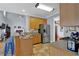 Open kitchen with stainless steel refrigerator and breakfast bar at 625 Piping Rock Pt, Lawrenceville, GA 30043