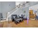 Open living space features hardwood floors, high ceilings, and a staircase leading to upper level at 625 Piping Rock Pt, Lawrenceville, GA 30043