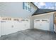 Two-car garage with white doors and black hardware at 714 Settlers Xing, Canton, GA 30114