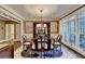 Formal dining room with hardwood floors, chandelier, and large windows at 1425 Landings Chase, Alpharetta, GA 30005